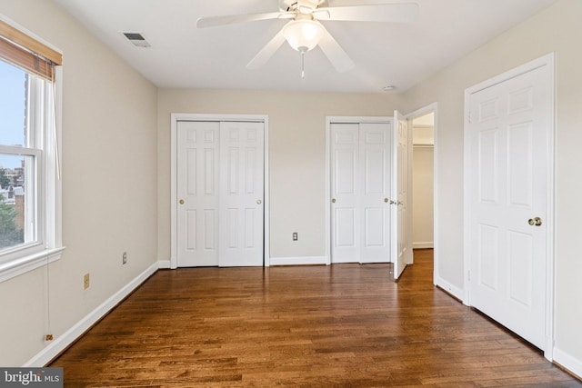 1803 T St NW Unit 11, Washington, DC 20009 - unfurnished bedroom with wood finished floors, multiple closets, and a ceiling fan