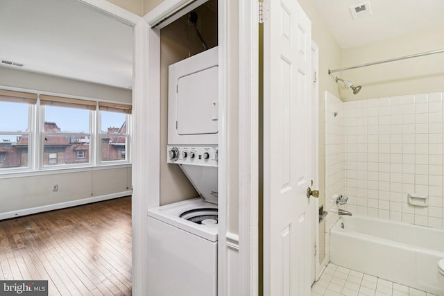 1803 T St NW Unit 11, Washington, DC 20009 - washroom featuring estacked washer and dryer and hardwood / wood-style floors