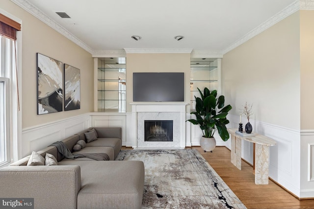 1803 T St NW Unit 11, Washington, DC 20009 - living room featuring wood finished floors, plenty of natural light, ornamental molding, a premium fireplace, and wainscoting