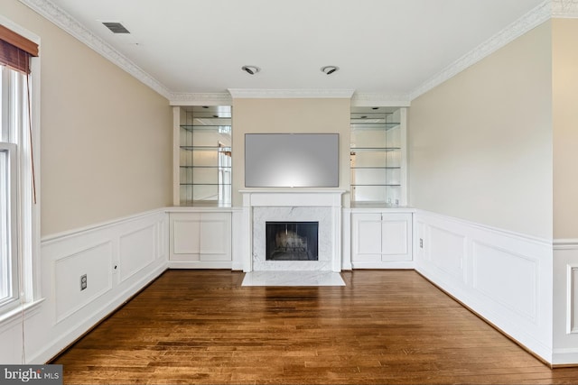1803 T St NW Unit 11, Washington, DC 20009 - unfurnished living room featuring wood finished floors, a fireplace, ornamental molding, healthy amount of natural light, and wainscoting