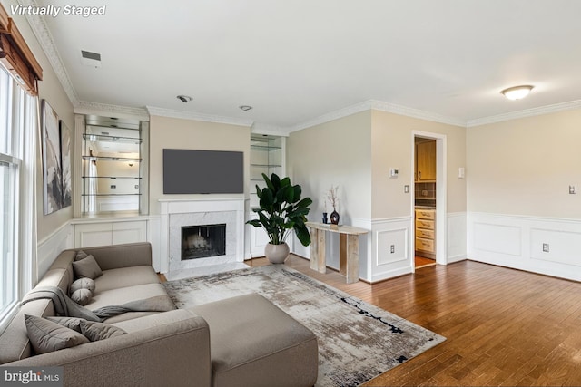1803 T St NW Unit 11, Washington, DC 20009 - living area featuring wood finished floors, ornamental molding, a wainscoted wall, and a premium fireplace
