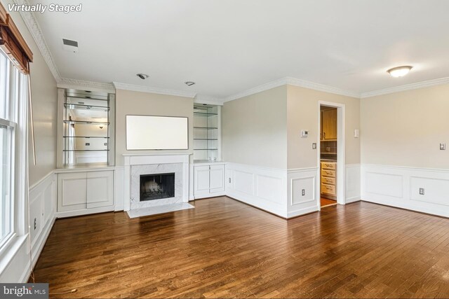 1803 T St NW Unit 11, Washington, DC 20009 - unfurnished living room featuring dark wood-type flooring, ornamental molding, a wainscoted wall, a high end fireplace, and a decorative wall
