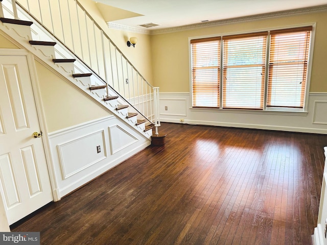 1803 T St NW Unit 11, Washington, DC 20009 - unfurnished living room with a wainscoted wall, dark wood finished floors, stairs, crown molding, and a decorative wall