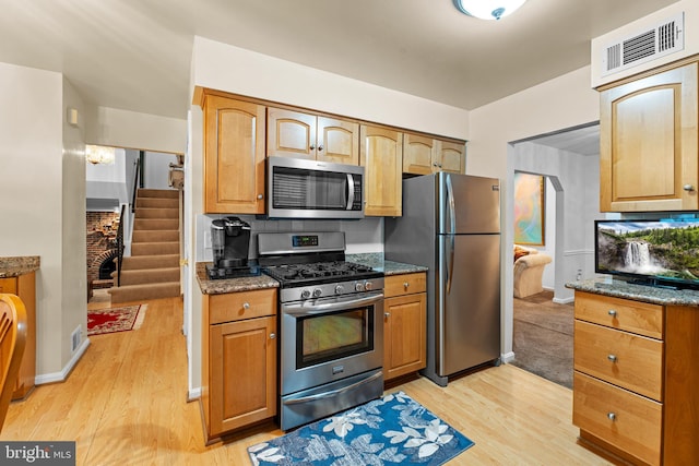 5139 Celestial Way, Columbia, MD 21044 - kitchen featuring appliances with stainless steel finishes, light wood-style flooring, and dark stone counters