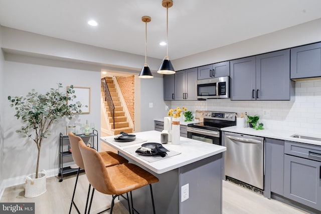 3910 E Pratt St, Baltimore, MD 21224 - kitchen with stainless steel appliances, backsplash, a kitchen island, light countertops, and recessed lighting