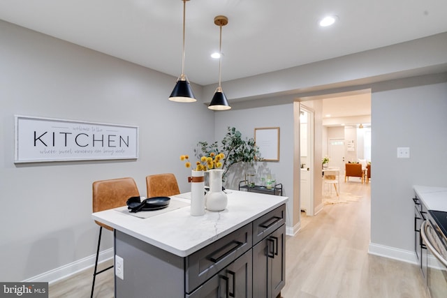 3910 E Pratt St, Baltimore, MD 21224 - kitchen featuring light wood-style flooring, stainless steel electric stove, recessed lighting, decorative light fixtures, and a breakfast bar