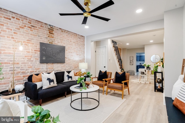 3910 E Pratt St, Baltimore, MD 21224 - living room featuring stairs, ceiling fan, light wood-style flooring, brick wall, and recessed lighting