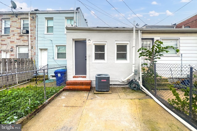 3910 E Pratt St, Baltimore, MD 21224 - rear view of property featuring stucco siding and a patio area