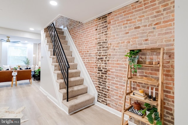 3910 E Pratt St, Baltimore, MD 21224 - stairs with wood finished floors, recessed lighting, and brick wall
