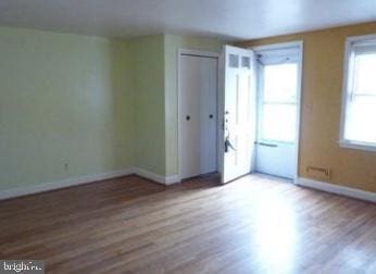 1527 Ingleside Ave, Baltimore, MD 21207 - empty room featuring plenty of natural light and wood finished floors