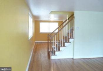 1527 Ingleside Ave, Baltimore, MD 21207 - stairs with baseboards and wood finished floors