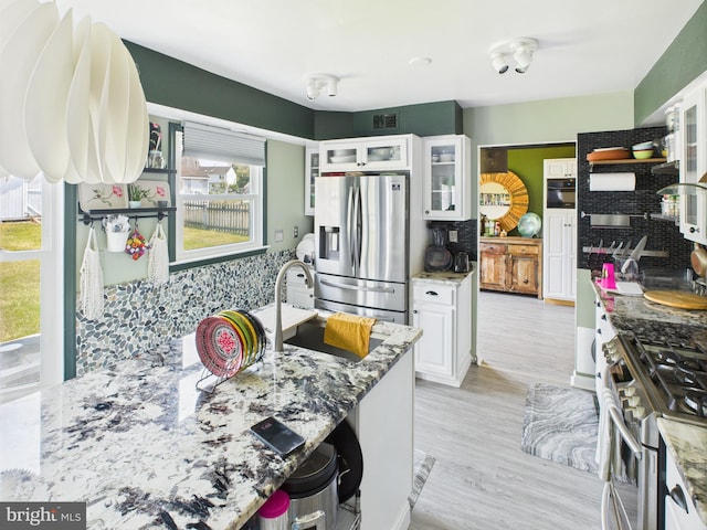 2101 Waterleaf Way, Bowie, MD 20721 - kitchen with stainless steel appliances, backsplash, white cabinets, stone countertops, and glass insert cabinets