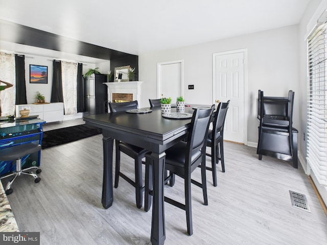 2101 Waterleaf Way, Bowie, MD 20721 - dining area with a brick fireplace and light wood-style floors