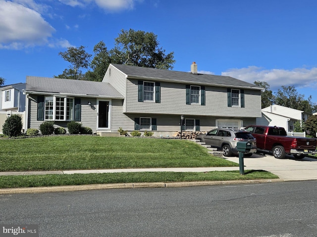 27 Dunlin Way, Sicklerville, NJ 08081 - split level home featuring concrete driveway, a front yard, a chimney, and an attached garage