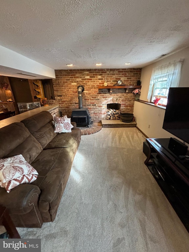 27 Dunlin Way, Sicklerville, NJ 08081 - living room with carpet flooring, a wood stove, a textured ceiling, and brick wall