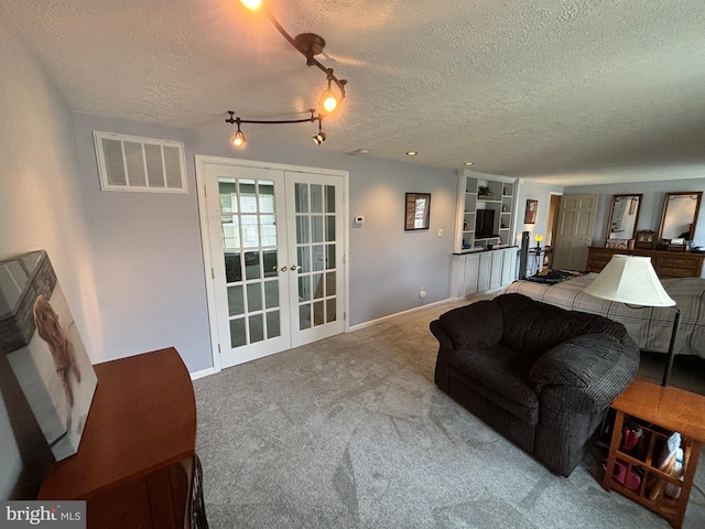 27 Dunlin Way, Sicklerville, NJ 08081 - living room featuring french doors, a textured ceiling, and carpet