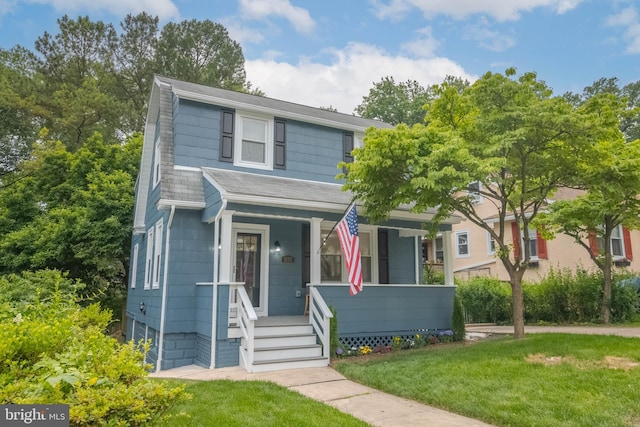 1117 Overbrook Rd, Baltimore, MD 21239 - view of front of house featuring a porch, a front lawn, and a shingled roof