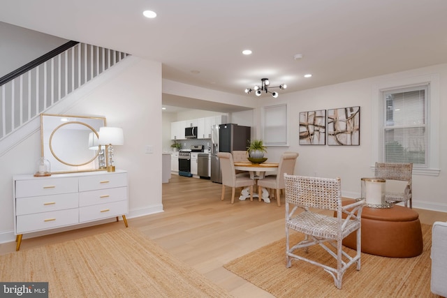 1117 Overbrook Rd, Baltimore, MD 21239 - living area with light wood-type flooring, recessed lighting, stairway, and a chandelier
