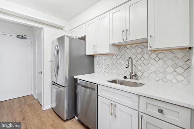 600 Roosevelt Blvd Unit 316, Falls Church, VA 22044 - kitchen with stainless steel appliances, light countertops, backsplash, and light wood-style flooring