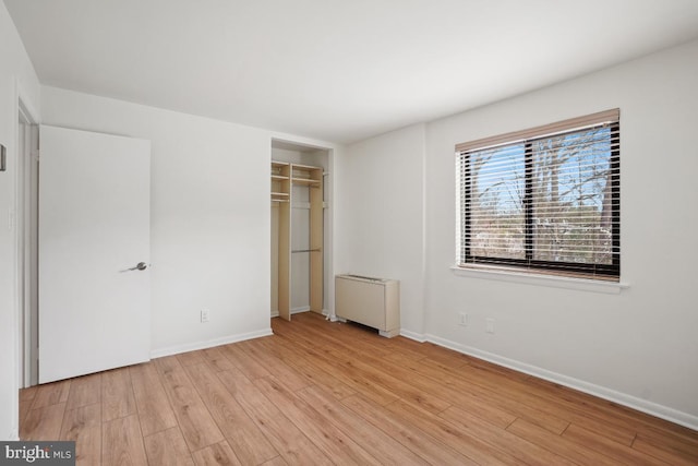 600 Roosevelt Blvd Unit 316, Falls Church, VA 22044 - unfurnished bedroom featuring radiator, light wood-style flooring, and a closet