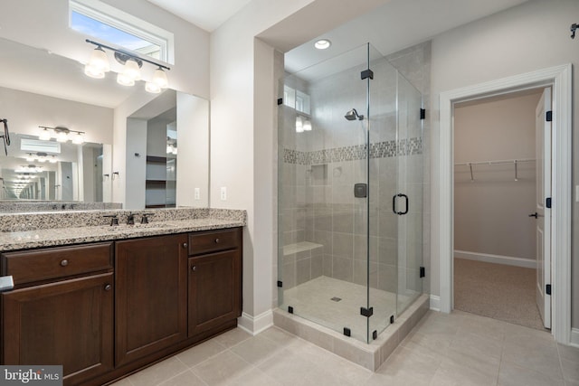 116 Grosbeak Ct, Lake Frederick, VA 22630 - bathroom with vanity, a stall shower, tile patterned floors, a walk in closet, and recessed lighting