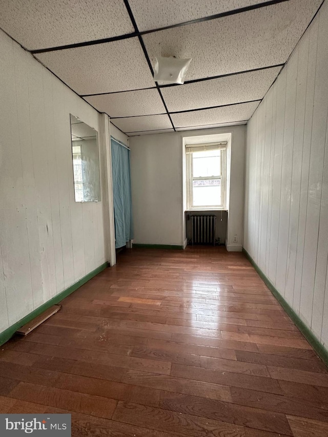 1825 S 8th St, Philadelphia, PA 19148 - unfurnished room with radiator, hardwood / wood-style floors, and wood walls