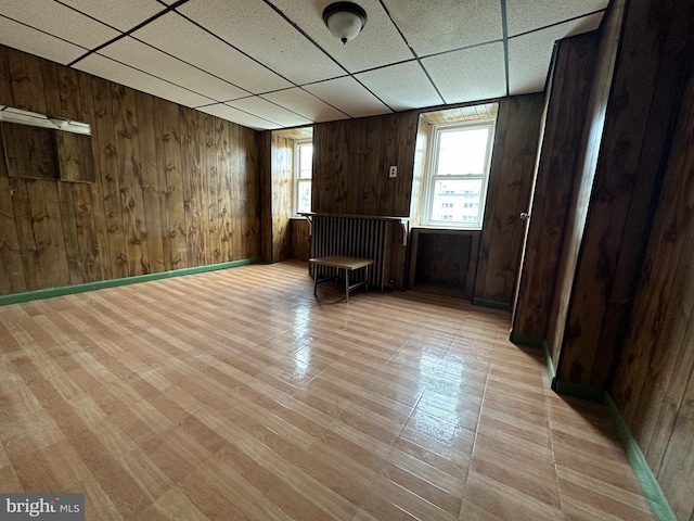 1825 S 8th St, Philadelphia, PA 19148 - unfurnished room with a drop ceiling, wood walls, and light wood-style flooring
