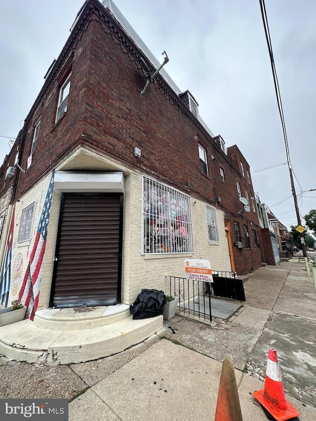 1825 S 8th St, Philadelphia, PA 19148 - view of property exterior with brick siding and a garage
