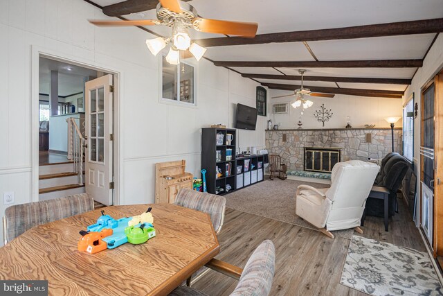 3735 Donegal Ln, Brookhaven, PA 19015 - dining space with a ceiling fan, wood finished floors, a stone fireplace, a decorative wall, and stairway