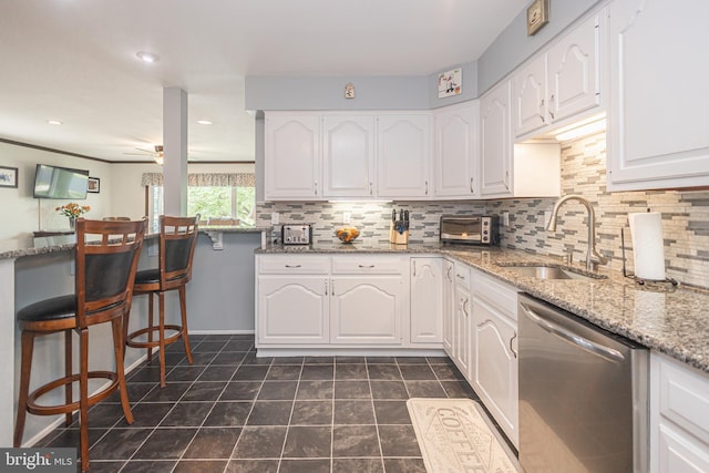 3735 Donegal Ln, Brookhaven, PA 19015 - kitchen with dishwasher, white cabinets, light stone countertops, backsplash, and recessed lighting