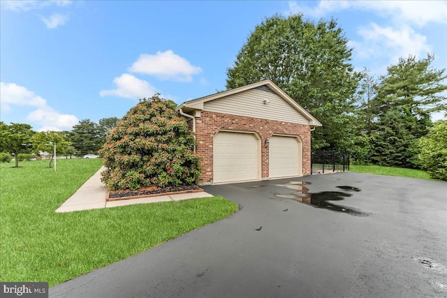 228 Benjamin Blvd, Bear, DE 19701 - view of front of home with brick siding, driveway, a front lawn, and an attached garage
