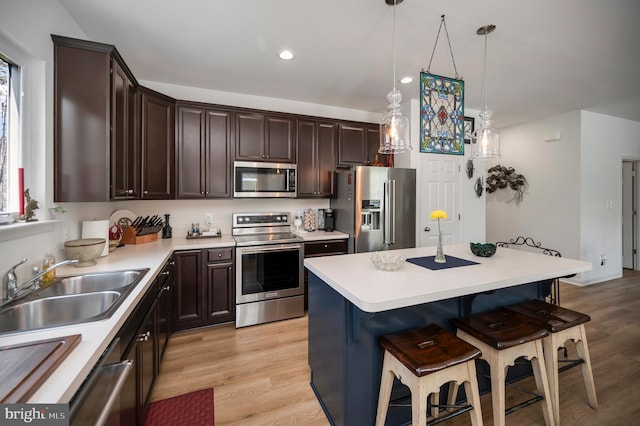 21 Walnut Grove Dr, Fredericksburg, VA 22406 - kitchen featuring stainless steel appliances, a kitchen bar, dark brown cabinets, light wood finished floors, and recessed lighting