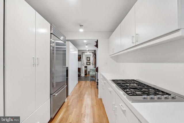 1330 Potomac School Rd, Mclean, VA 22101 - kitchen with light wood-style flooring, stainless steel appliances, white cabinetry, and light countertops
