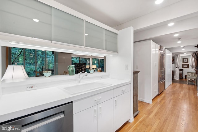 1330 Potomac School Rd, Mclean, VA 22101 - kitchen with dishwasher, light countertops, white cabinets, light wood-style flooring, and refrigerator