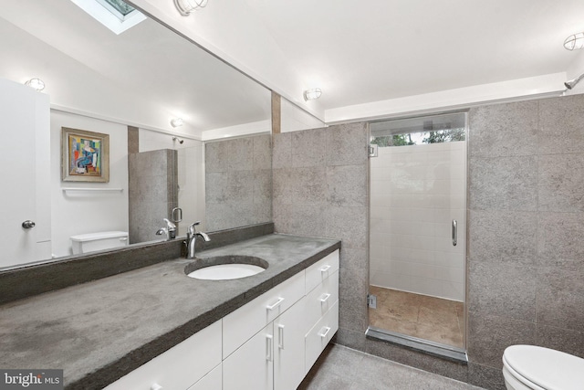 1330 Potomac School Rd, Mclean, VA 22101 - full bathroom with tile walls, vanity, a shower stall, tile patterned flooring, and a skylight