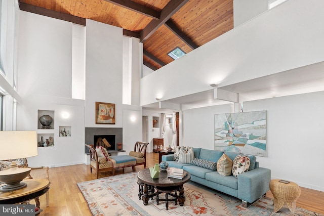 1330 Potomac School Rd, Mclean, VA 22101 - living area featuring a wooden ceiling with exposed beams, wood finished floors, high vaulted ceiling, built in features, and a fireplace with raised hearth
