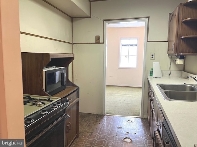 717 Garnet Rd, Wilmington, DE 19804 - kitchen with black appliances, open shelves, light countertops, and dark floors