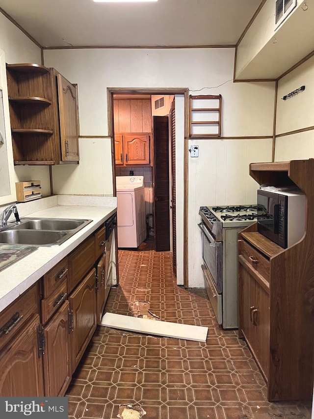 717 Garnet Rd, Wilmington, DE 19804 - kitchen featuring range with gas cooktop, dark flooring, open shelves, light countertops, and a wainscoted wall