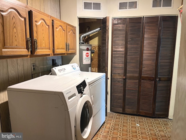 717 Garnet Rd, Wilmington, DE 19804 - washroom featuring water heater, washing machine and clothes dryer, and cabinet space
