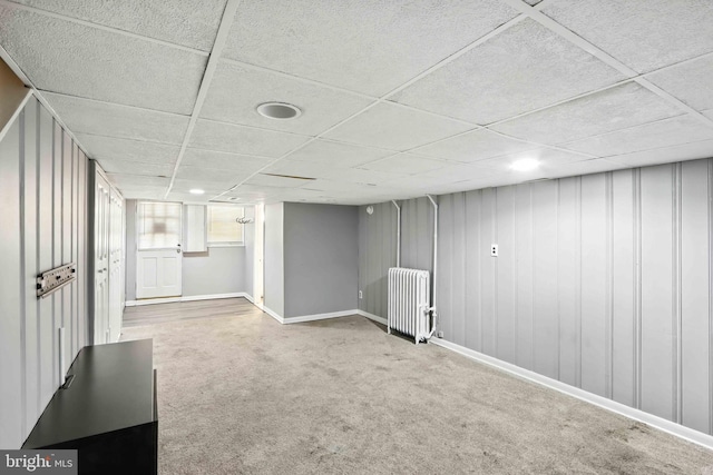 3714 Greenvale Rd, Baltimore, MD 21229 - basement featuring radiator, carpet, and a paneled ceiling