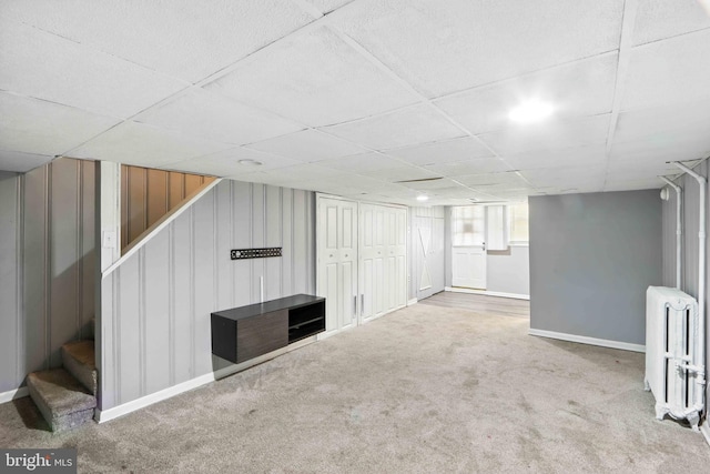3714 Greenvale Rd, Baltimore, MD 21229 - below grade area with radiator, stairs, carpet flooring, and a paneled ceiling