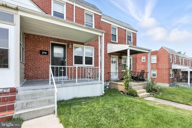 3714 Greenvale Rd, Baltimore, MD 21229 - multi unit property featuring a porch, brick siding, and a front yard