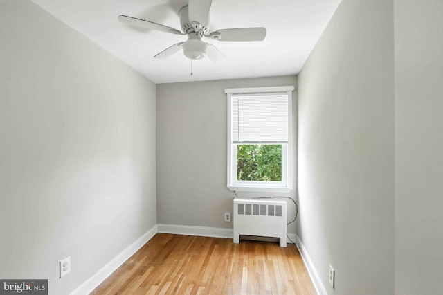 3714 Greenvale Rd, Baltimore, MD 21229 - spare room featuring radiator heating unit, light wood-style floors, and ceiling fan