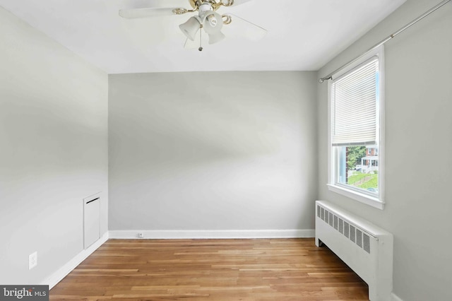3714 Greenvale Rd, Baltimore, MD 21229 - spare room featuring radiator, a ceiling fan, and light wood-style flooring