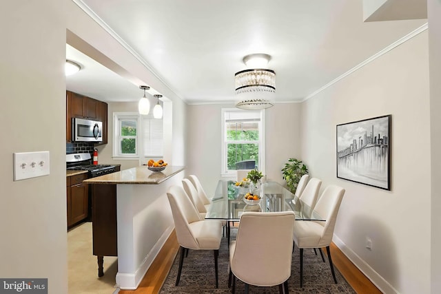 3714 Greenvale Rd, Baltimore, MD 21229 - dining area with crown molding and light wood-type flooring