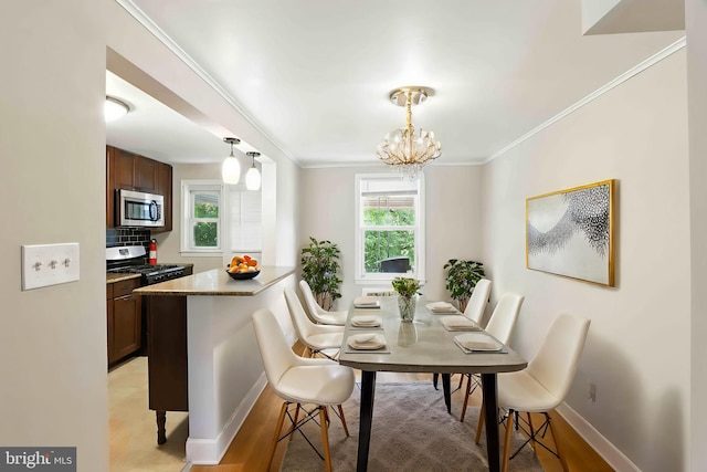 3714 Greenvale Rd, Baltimore, MD 21229 - dining space with a chandelier, crown molding, and light wood-style flooring