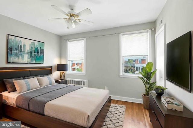 3714 Greenvale Rd, Baltimore, MD 21229 - bedroom featuring radiator heating unit, wood finished floors, and a ceiling fan