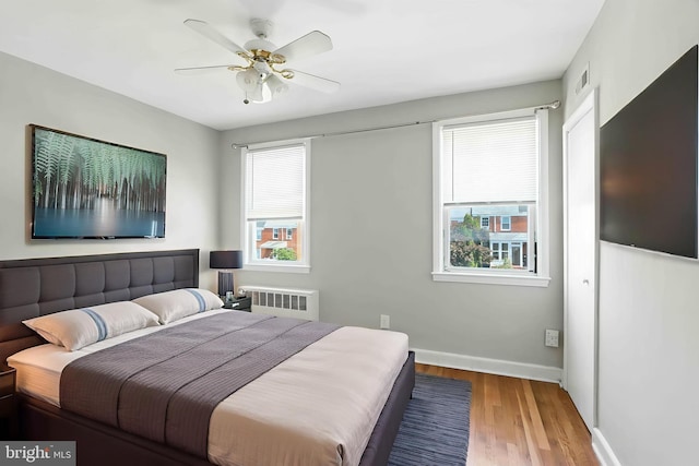 3714 Greenvale Rd, Baltimore, MD 21229 - bedroom with radiator heating unit, wood finished floors, and a ceiling fan