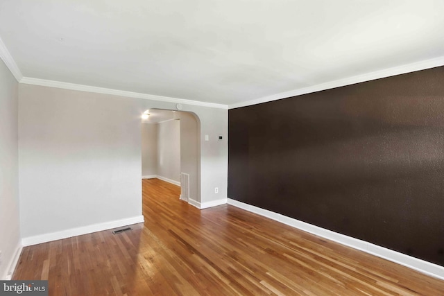3714 Greenvale Rd, Baltimore, MD 21229 - empty room with wood finished floors, ornamental molding, and arched walkways