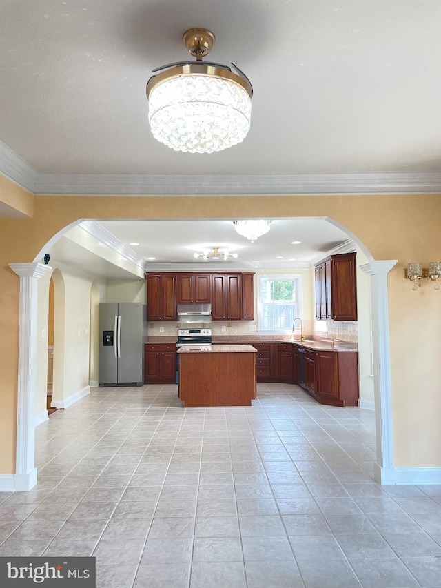 7212 Highland St, Springfield, VA 22150 - kitchen with appliances with stainless steel finishes, arched walkways, backsplash, crown molding, and light tile patterned flooring